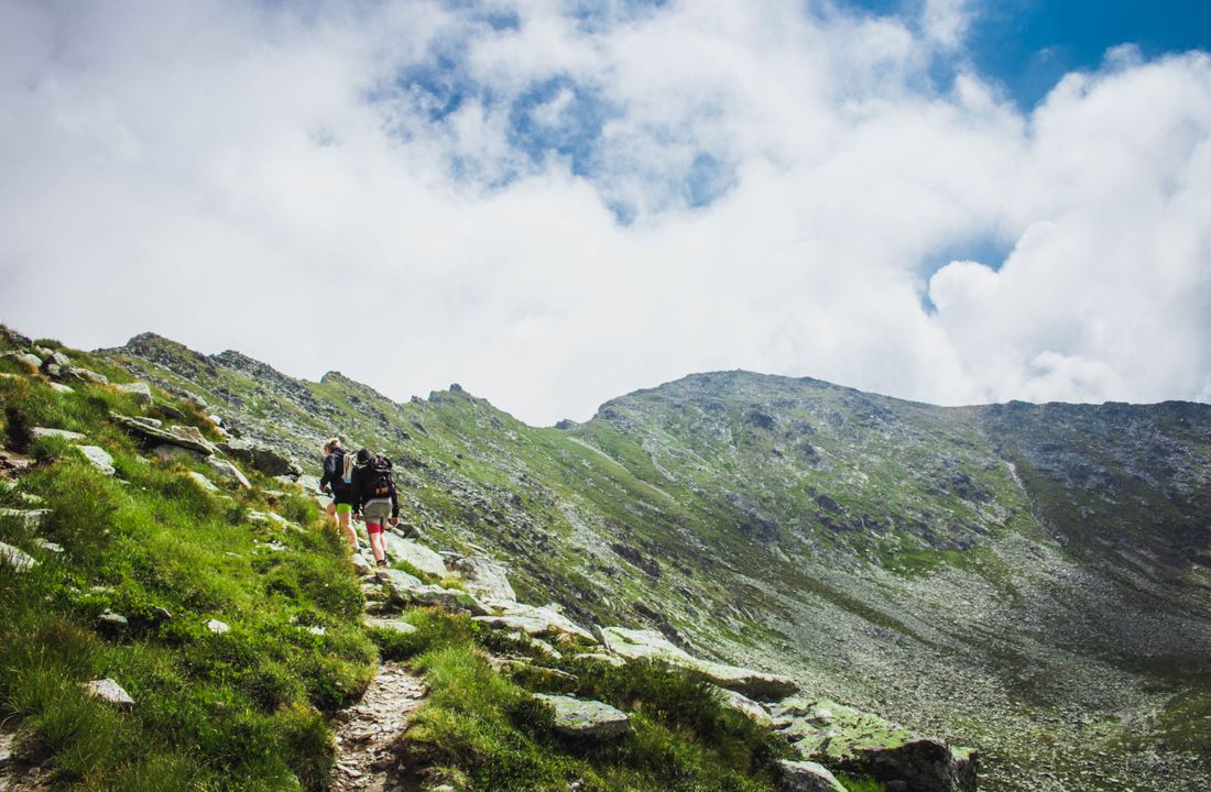 Hiker on a mountain ridge at first light
